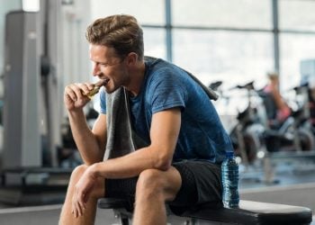 sportsman who consumes an energy and protein bar after training